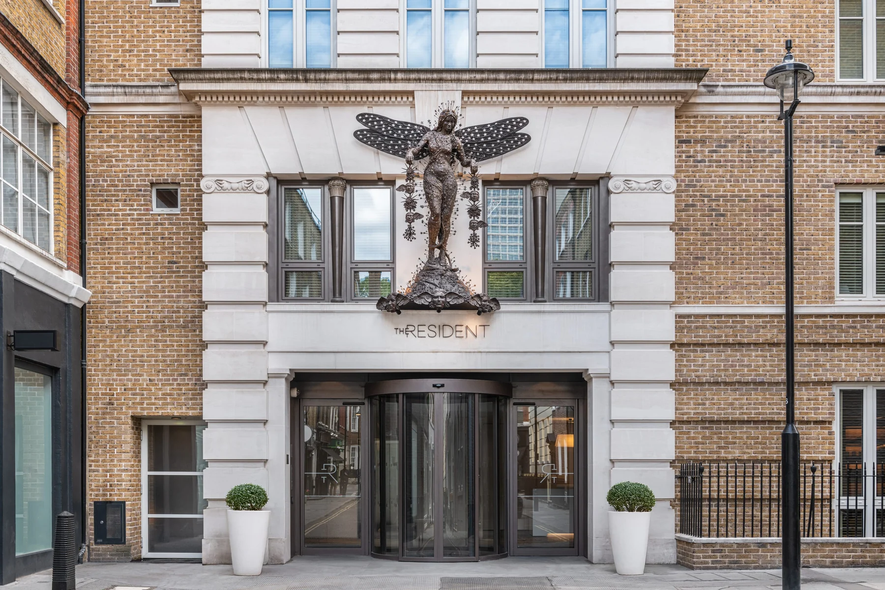The Resident Soho — The Resident Soho exterior with planters  size-full object-cover object-center