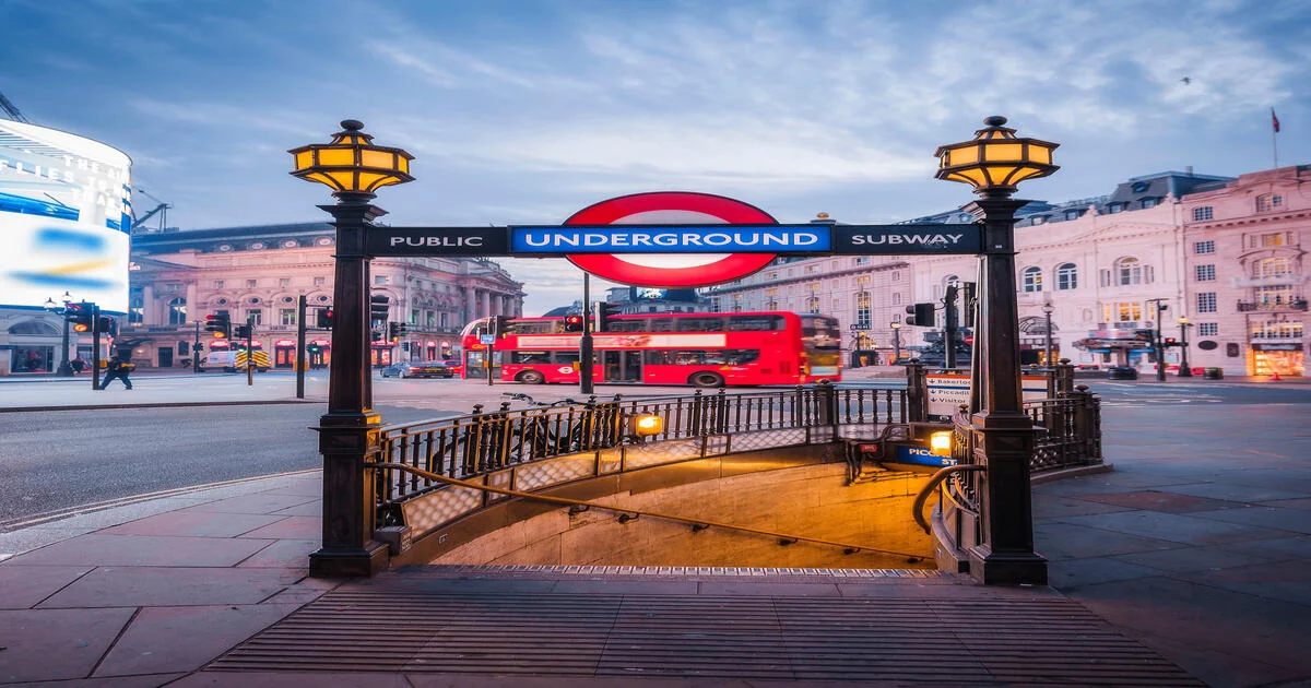 London — Piccadilly Circus, red double-decker bus and Underground entrance at dusk
