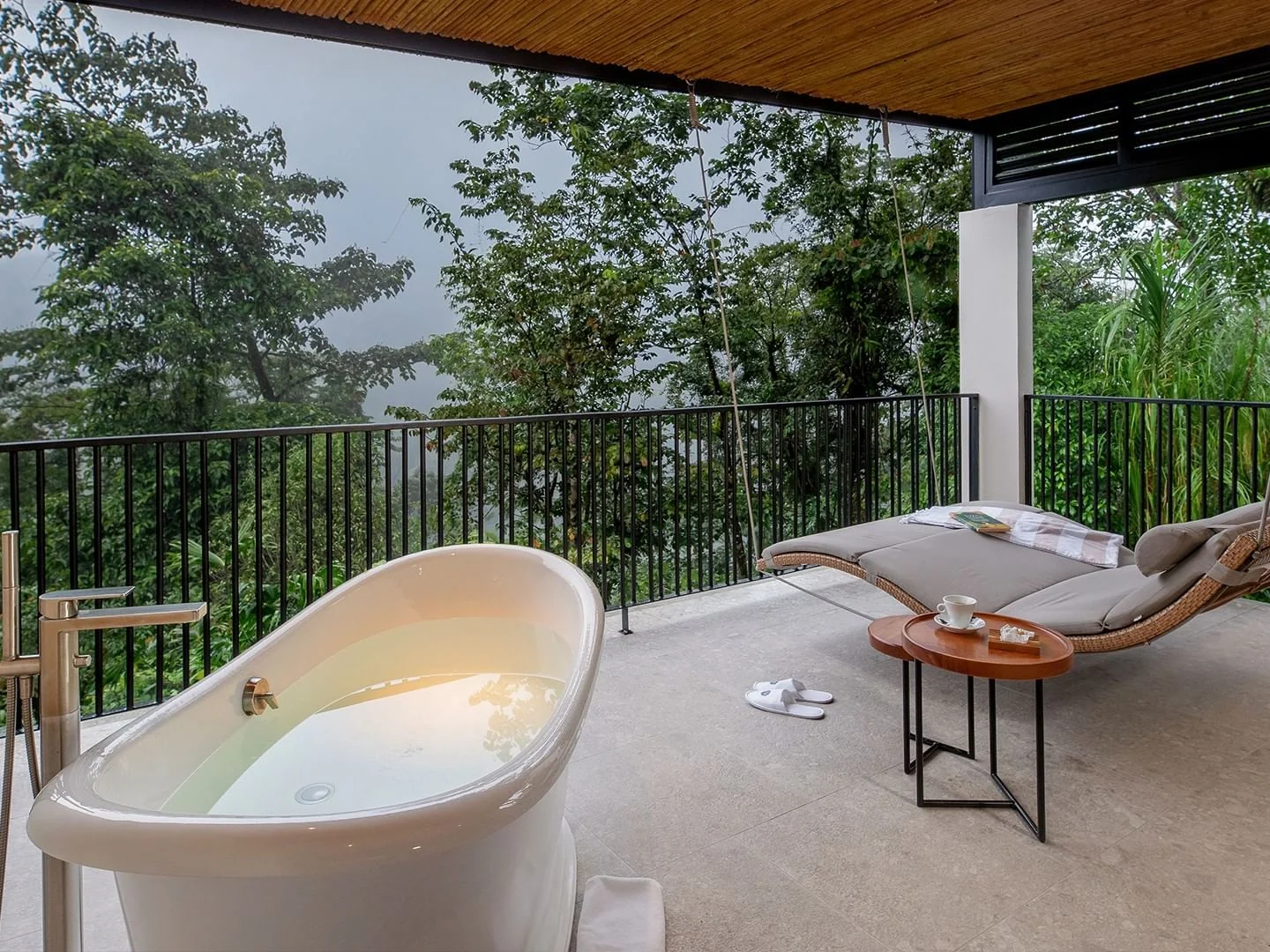 Tabacón Thermal Resort — Outdoor plunge pool and a hanging lounge chair in the Volcano View Suite at Tabacon Thermal Resort & Spa