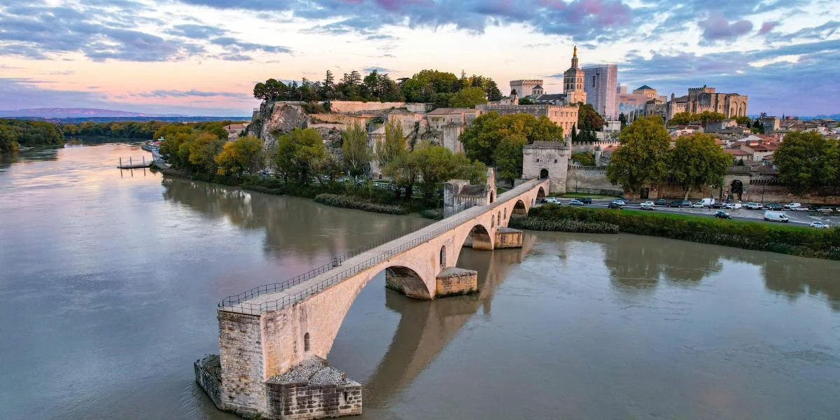 Avignon — Pont Saint-Bénézet and the walled city beside the Rhône at sunset