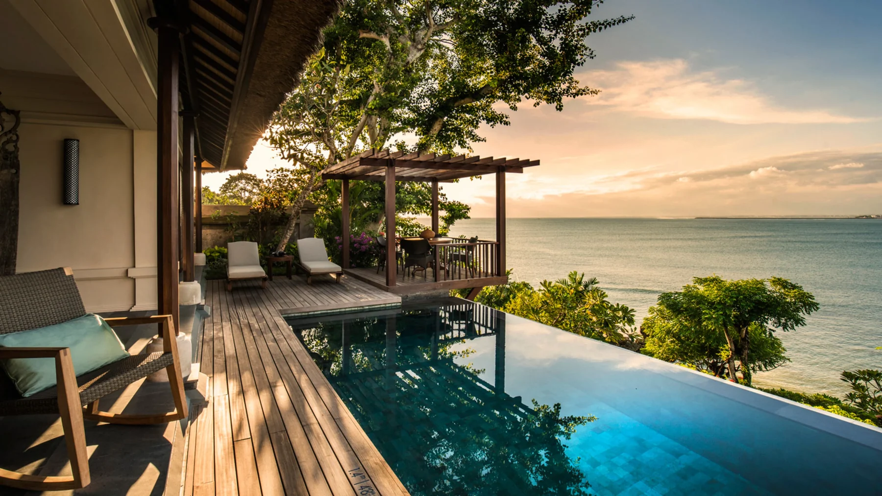 Four Seasons Jimbaran Bay — Sunset across an actual Jimbaran Bay villa terrace and pool; example accommodation category