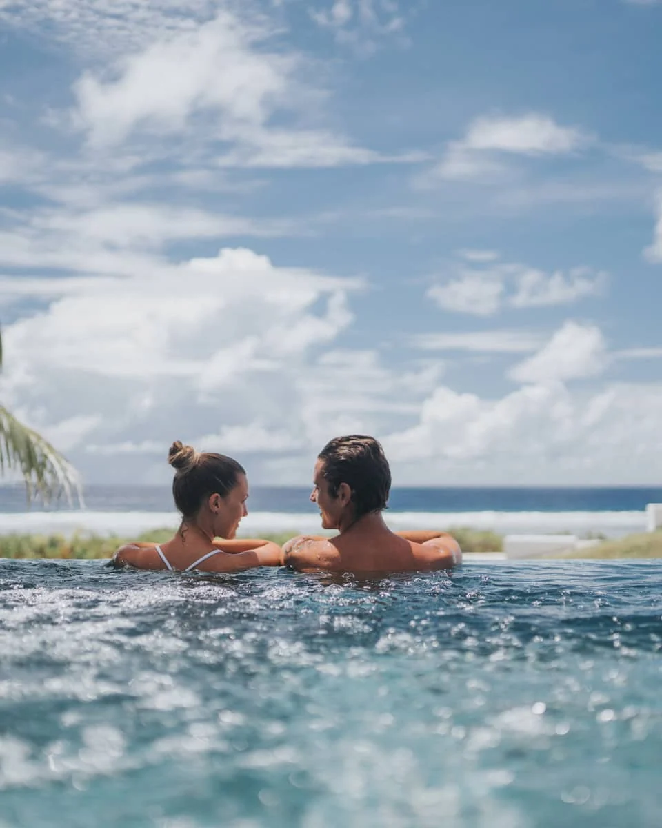 Four Seasons Bora Bora — Four Seasons Bora Bora — a couple relaxing beside a private overwater pool